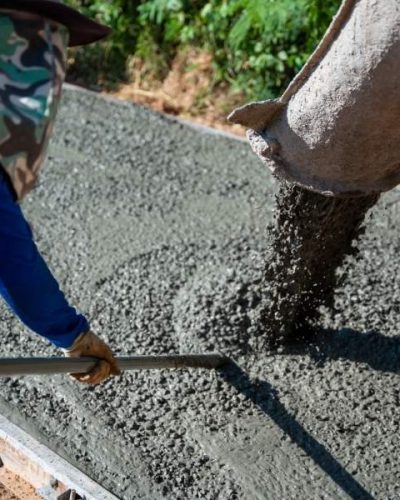 Concrete pouring during commercial concreting floors at road